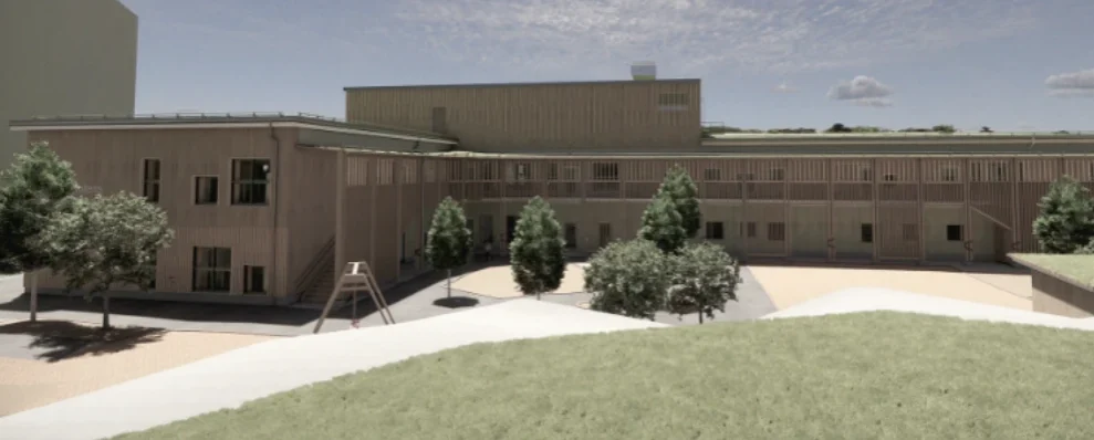 Exteriör av Bergfotens förskola med träfasad och innergård.